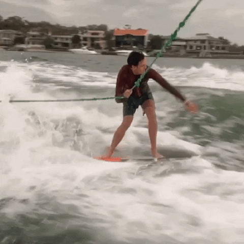 wakeboarder falls riding a wave gif