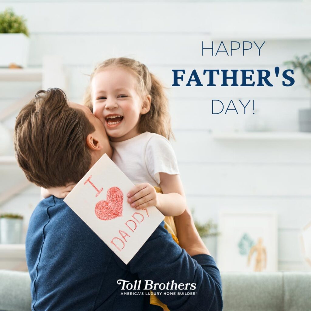 Happy Father's Day message with a picture of a white father with brown hair and a blue shirt holding his blonde daughter who is holding a card that says I heart daddy and there is a Toll Brothers logo at the bottom