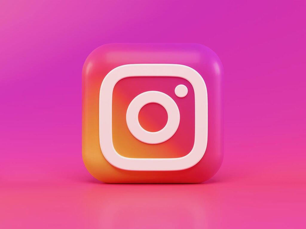 three dimensional computer generated image of the pink orange and white Instagram logo in front of a pink and purple background
